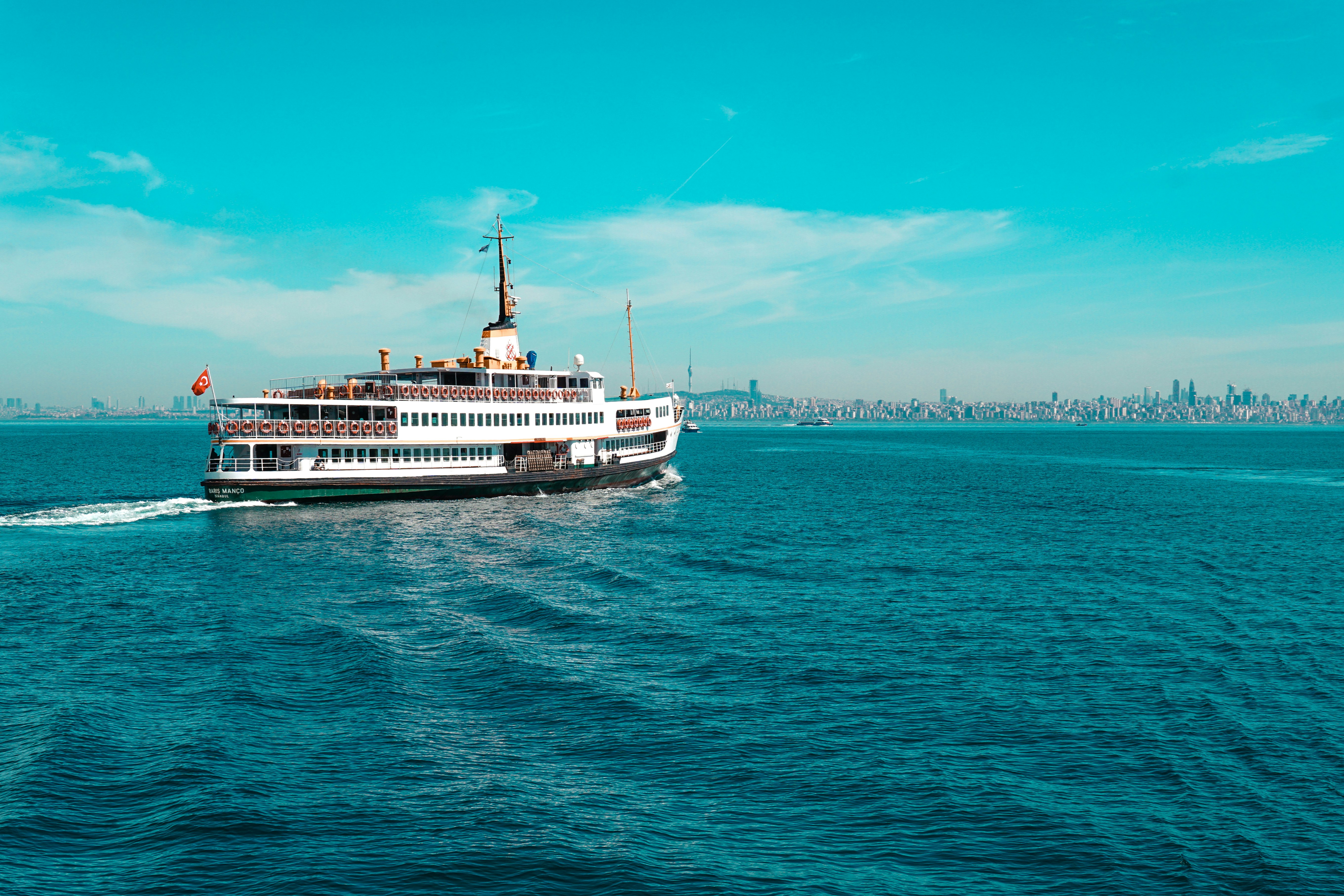 white ship on sea under blue sky during daytime