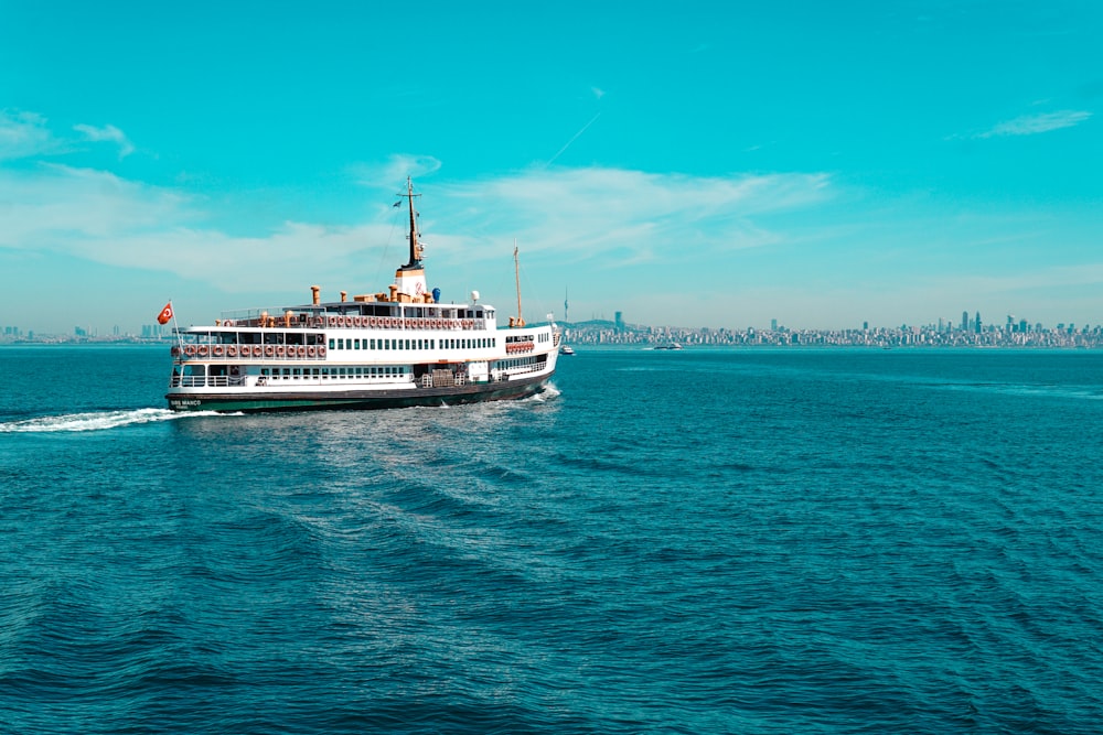 white ship on sea under blue sky during daytime