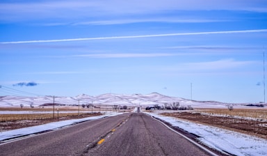 gray concrete road under blue sky during daytime