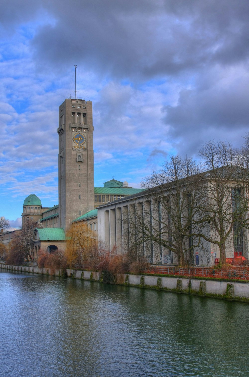 brown concrete building near body of water during daytime