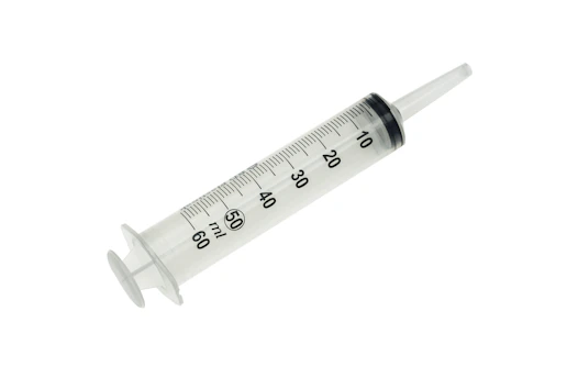 green and white medical syringe for injecting bacon