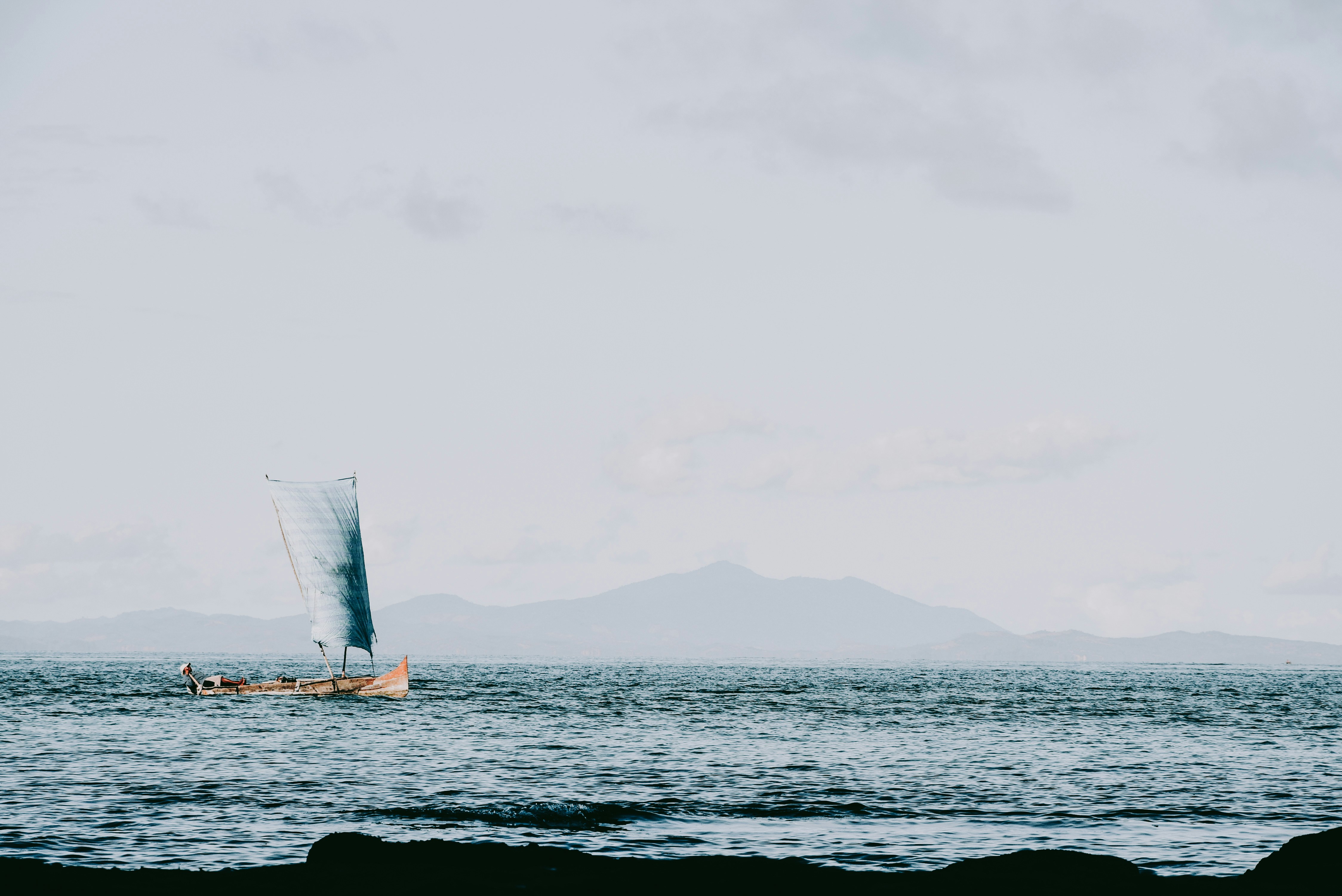 white sail boat on sea during daytime