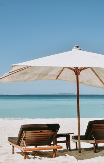 brown wooden chairs on beach during daytime