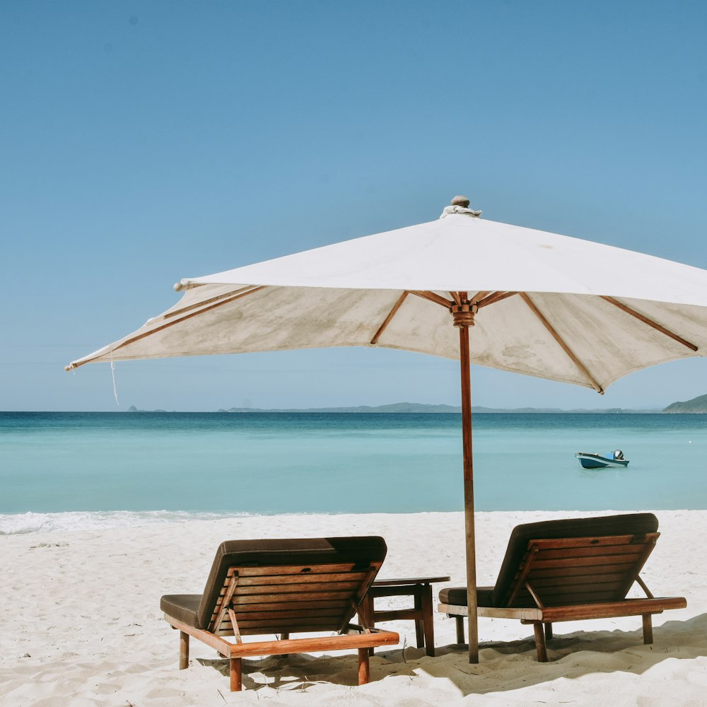 brown wooden chairs on beach during daytime