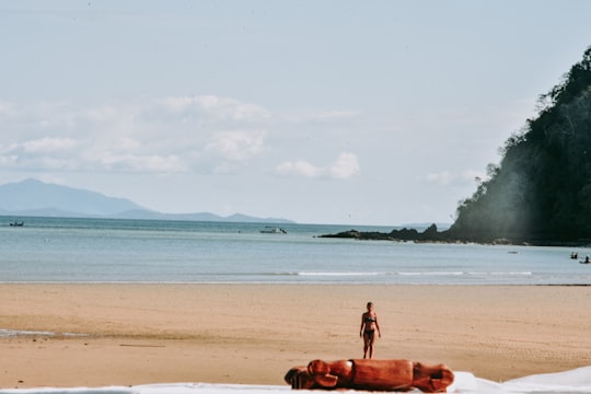 woman in white shirt walking on beach during daytime in Nosy Be Madagascar