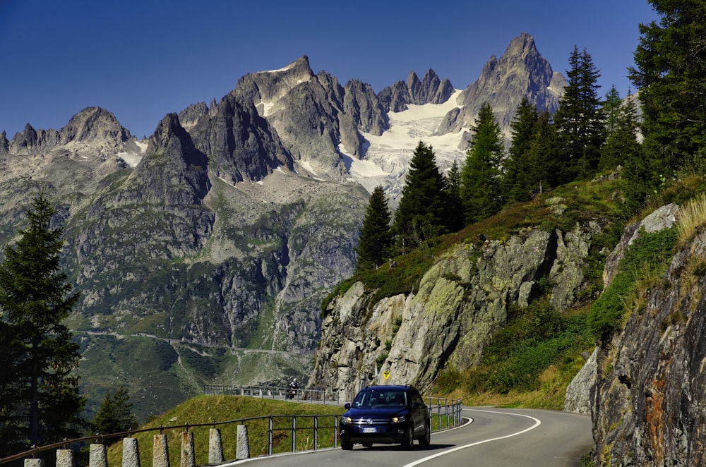 black suv on road near mountain range