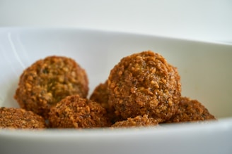 two brown cookies on white ceramic plate