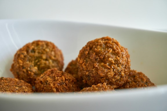two brown cookies on white ceramic plate