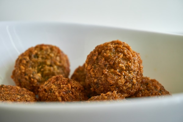 Two brown cookies on white ceramic plate