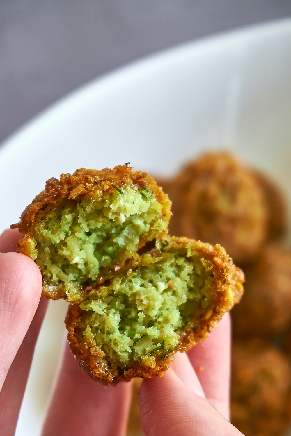 person holding brown and green food