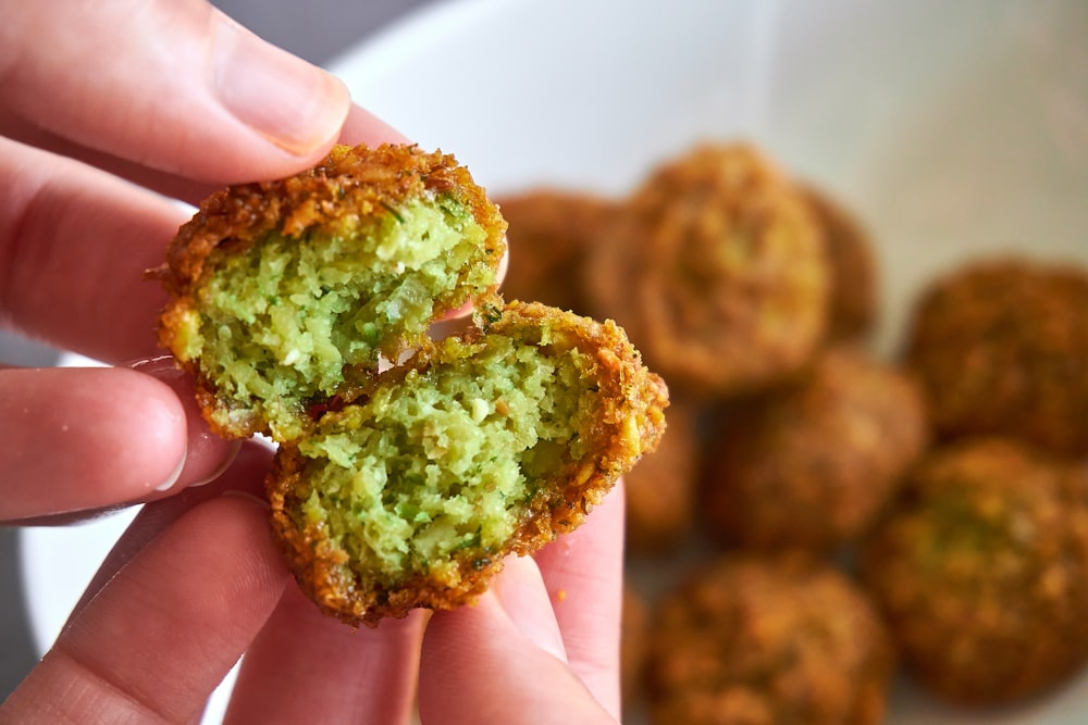 person holding brown and green food