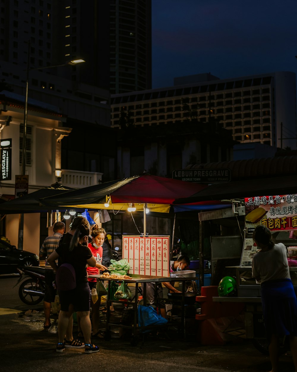 people walking on street during night time