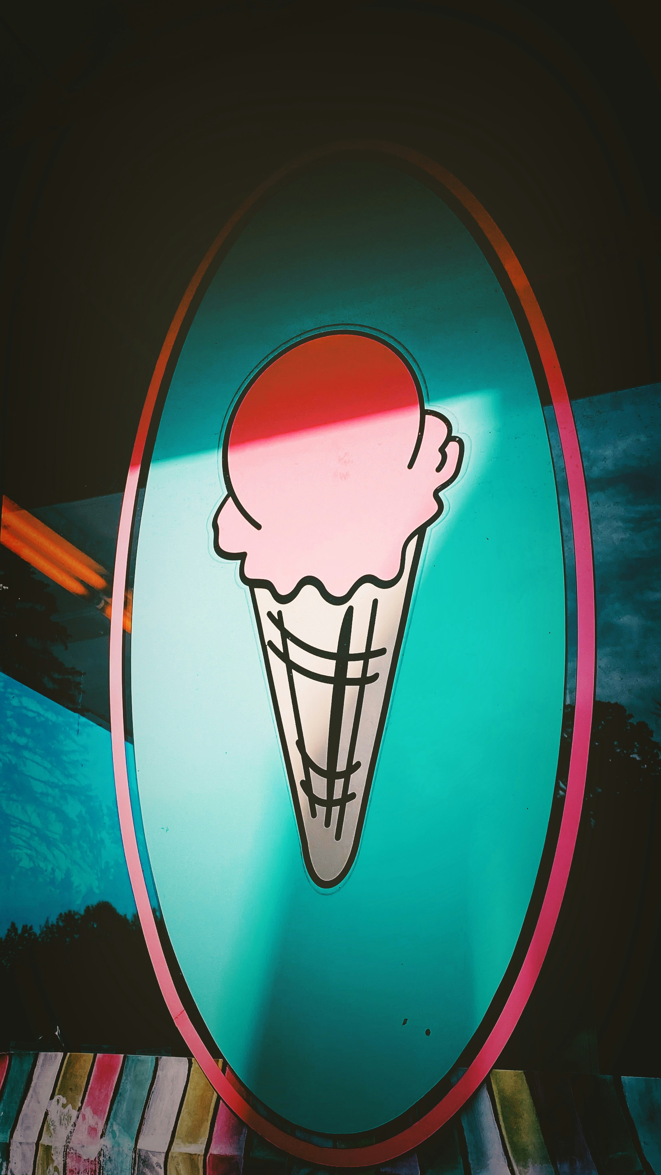 red and white surfboard on body of water