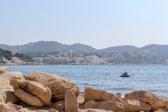 person riding on boat on sea during daytime in Moraira Spain