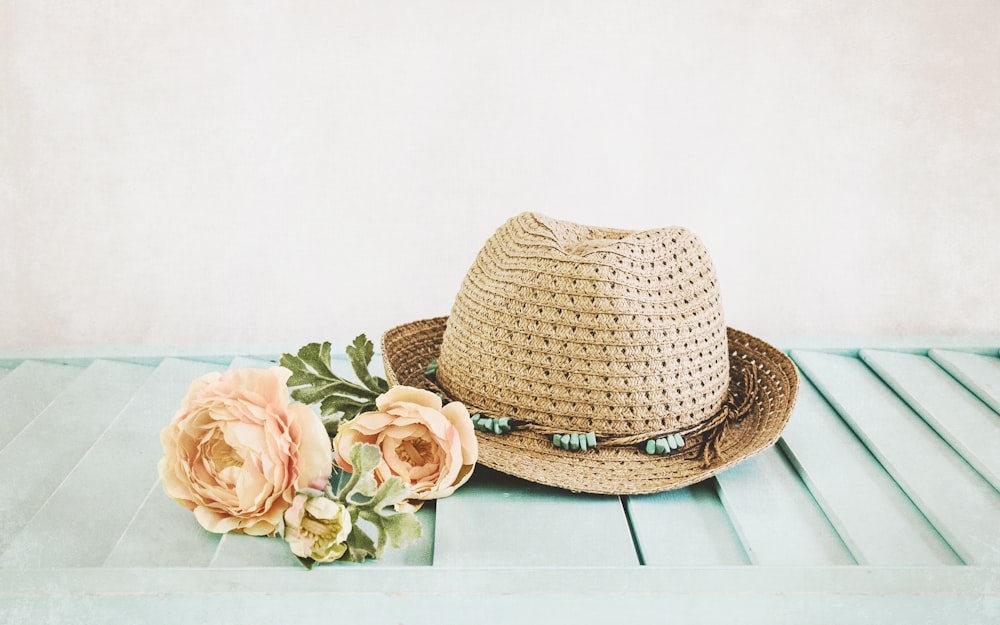 brown straw hat on white wooden table