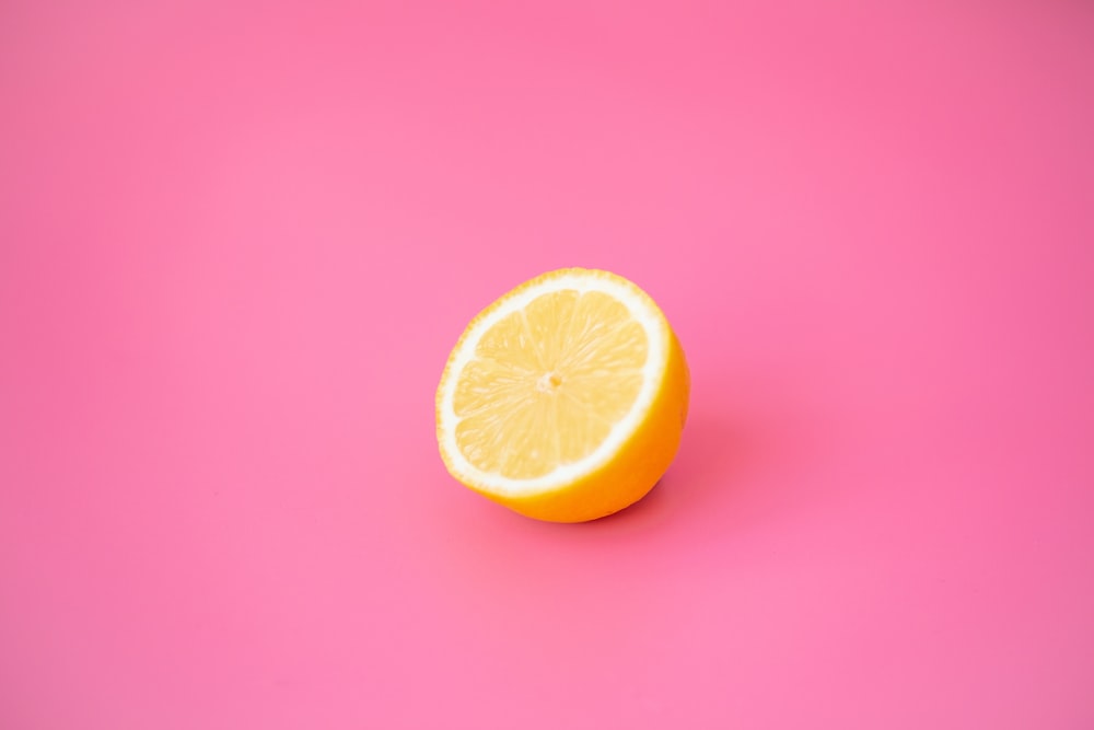 sliced lemon on red surface