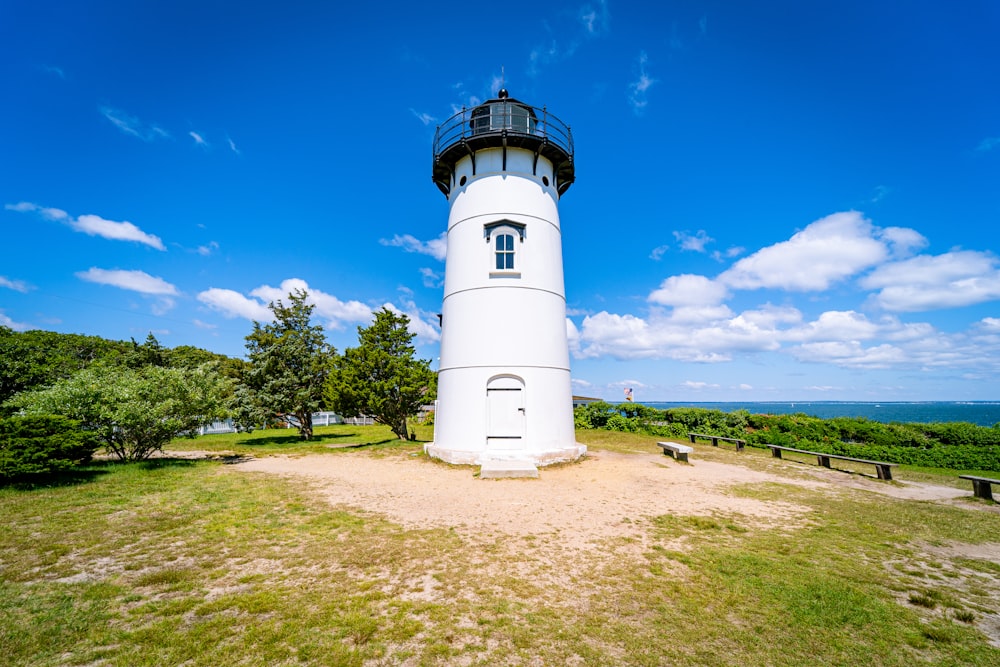 white and black lighthouse under blue sky during daytime