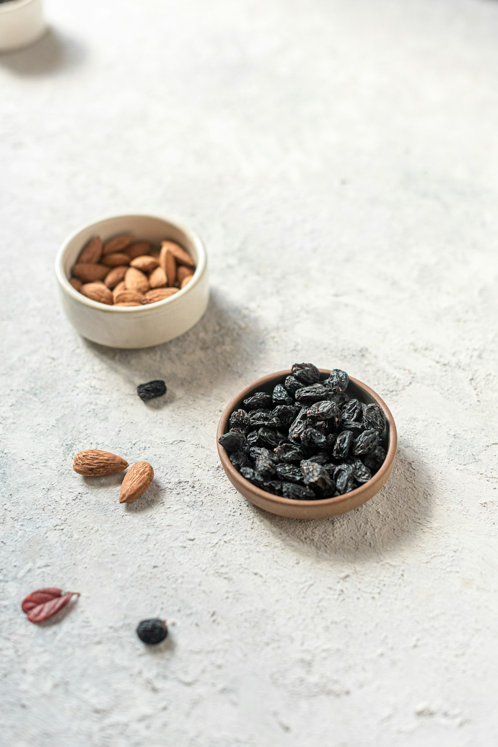 brown and black coffee beans on white ceramic bowl