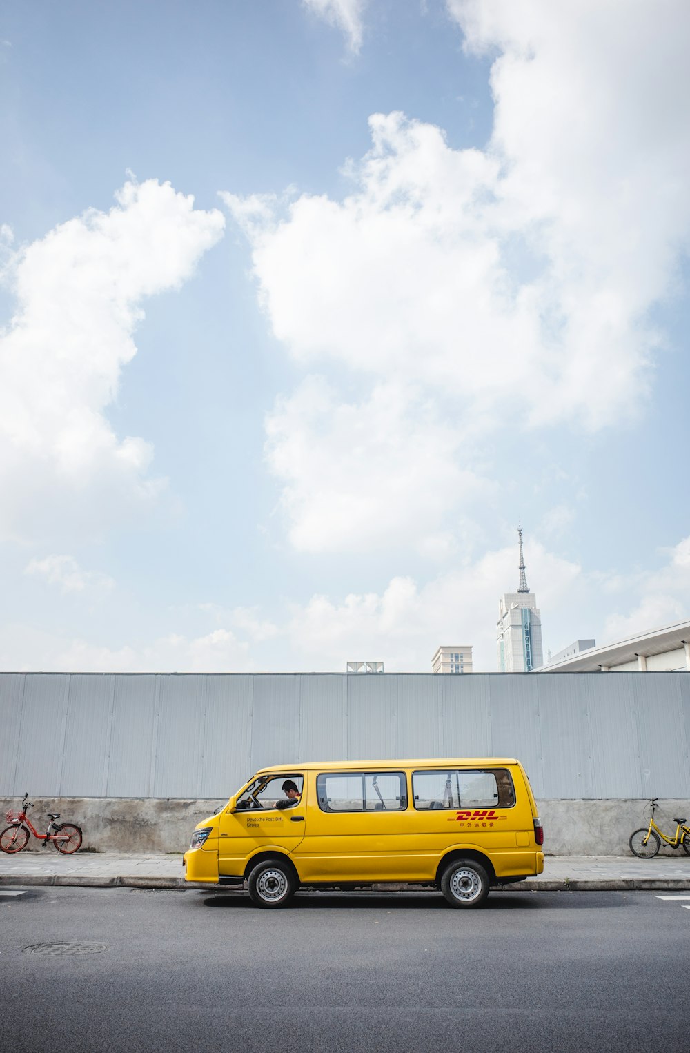 yellow car parked near white building