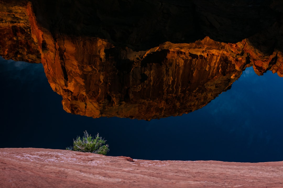 brown rock formation near body of water during daytime