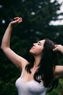 woman in white tank top holding her hair