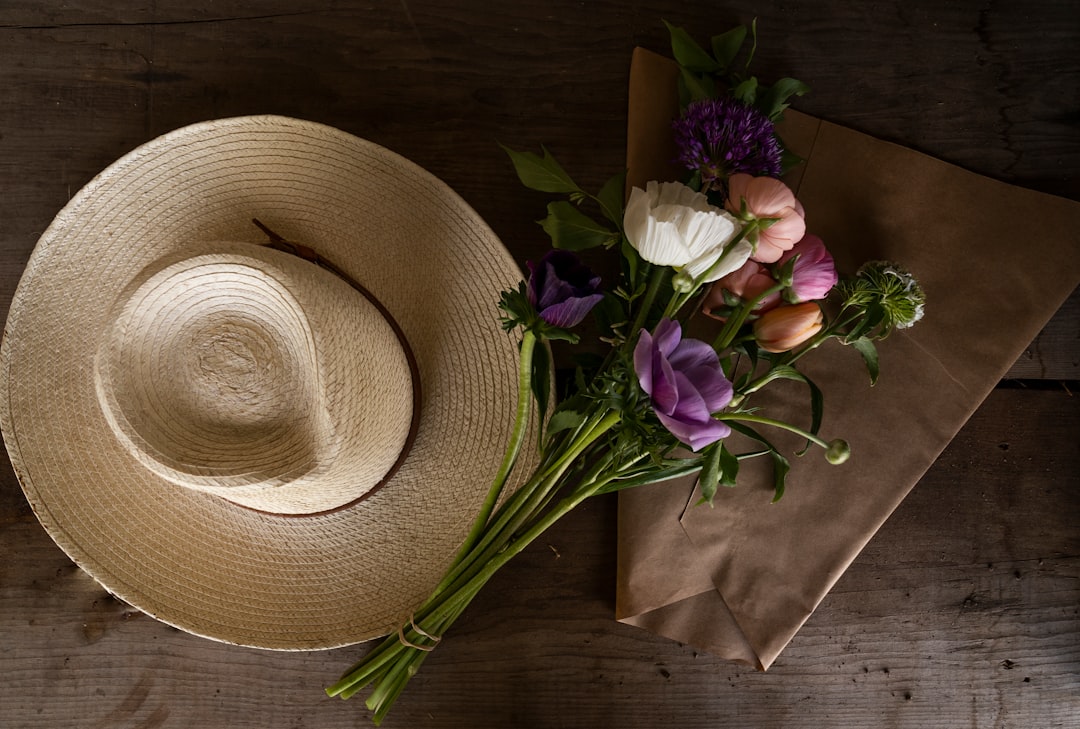 brown cowboy hat beside purple flower