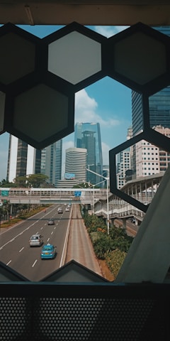 cars on road near city buildings during daytime