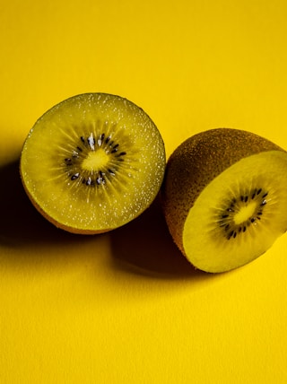 sliced green fruit on yellow surface