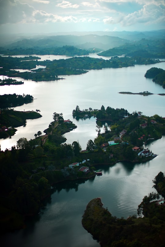 green trees on island surrounded by water during daytime in Rock of El Peñol Colombia