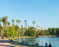 people sitting on concrete bench near body of water during daytime