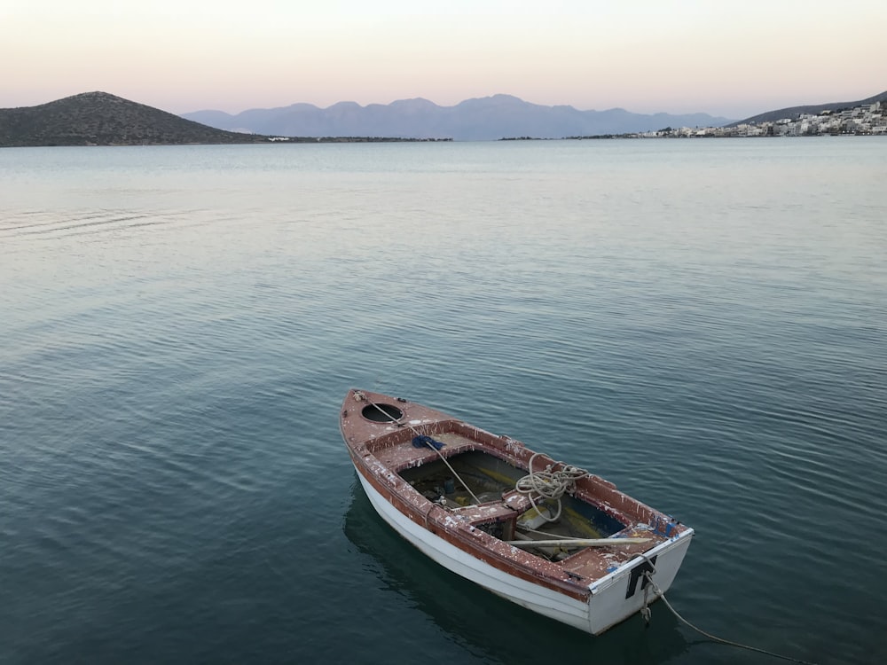 white and brown boat on body of water during daytime