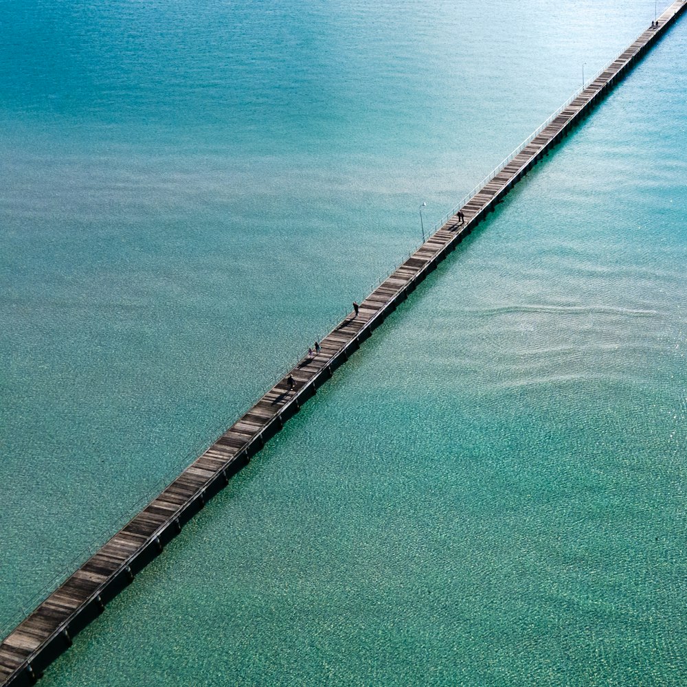 brown wooden dock on blue sea