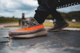 A close-up of trendy sneakers on a sidewalk.