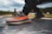 A close-up of a man wearing stylish shoes in a park.