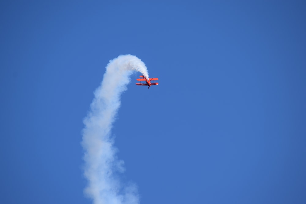 red and white jet plane in mid air