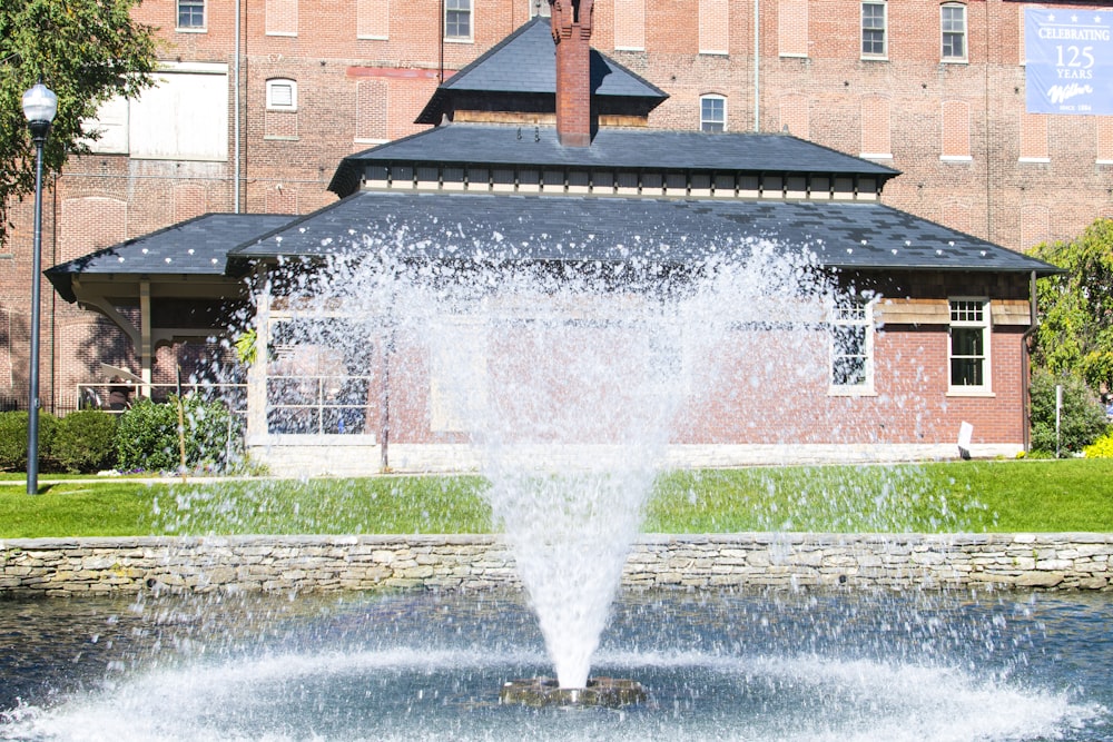 water fountain in front of brown brick building