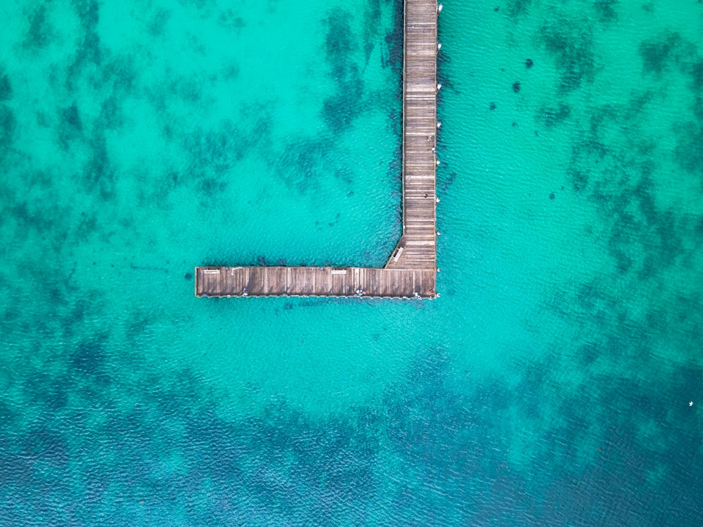 aerial view of brown wooden dock on body of water