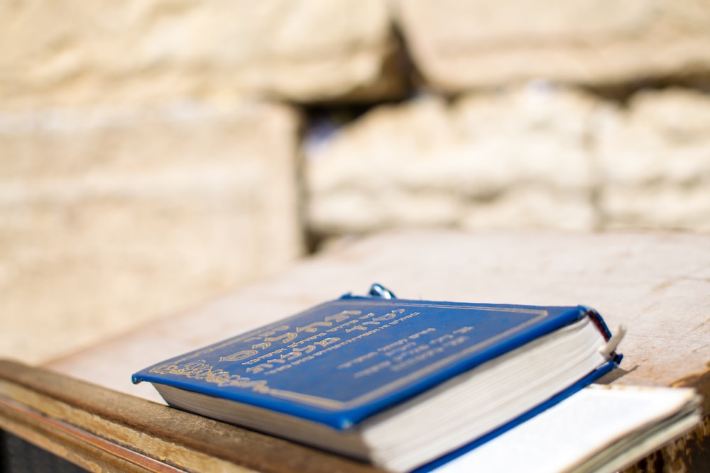 livro azul na mesa de madeira marrom