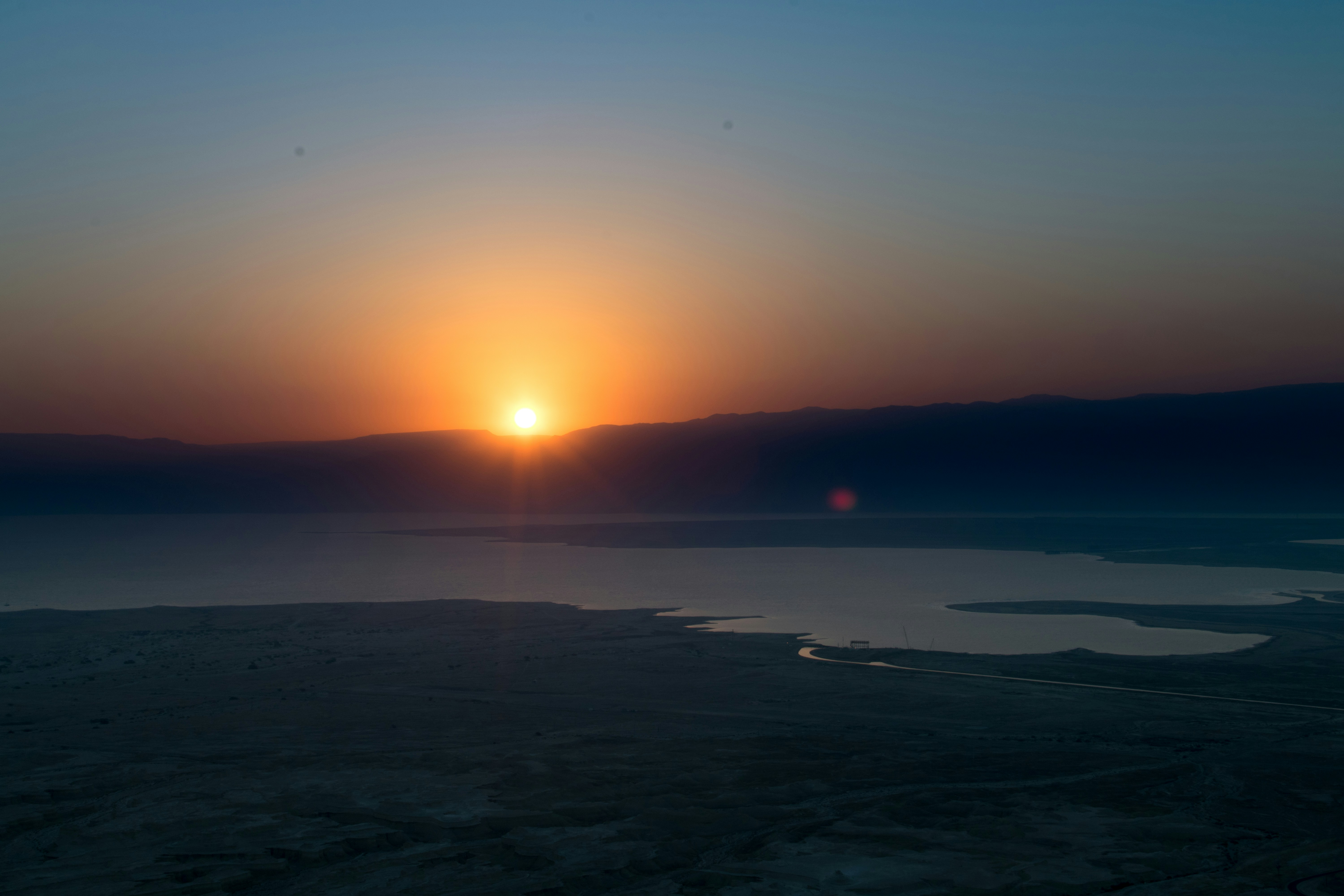 body of water during sunset