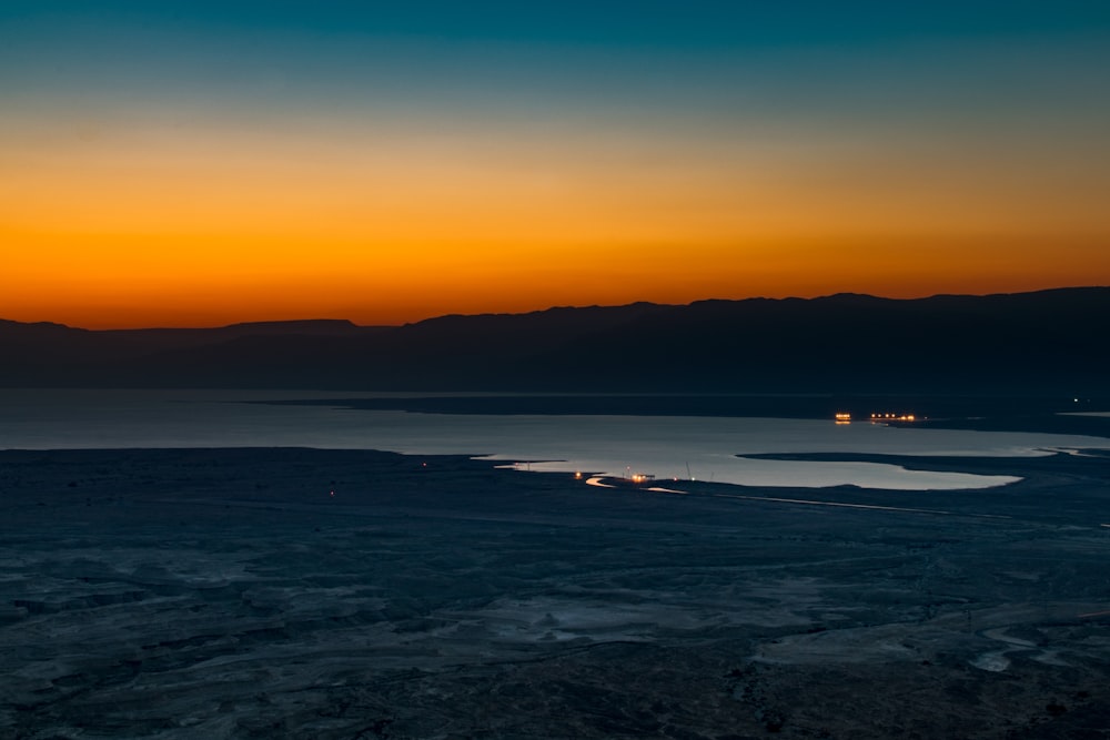 body of water during sunset