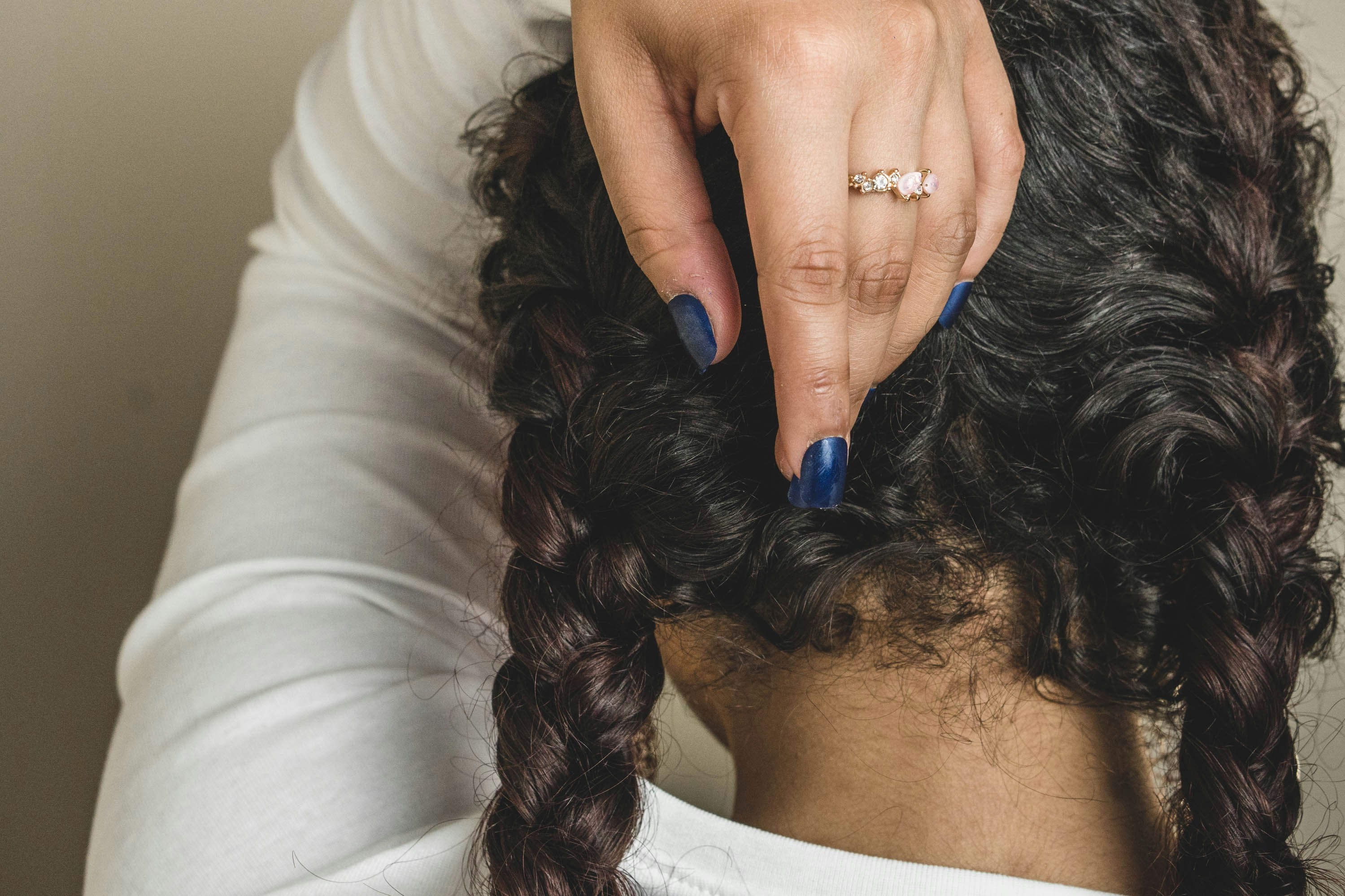 woman with blue manicure wearing silver ring wisconsin teams background
