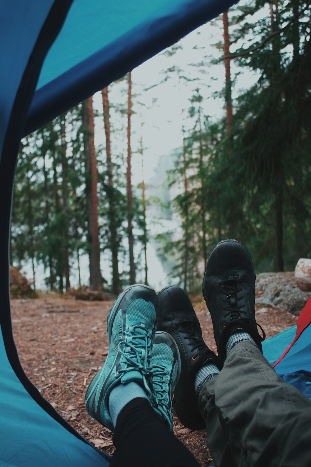 person in black and green hiking shoes