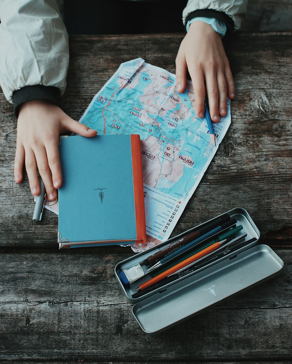 person holding blue and red book