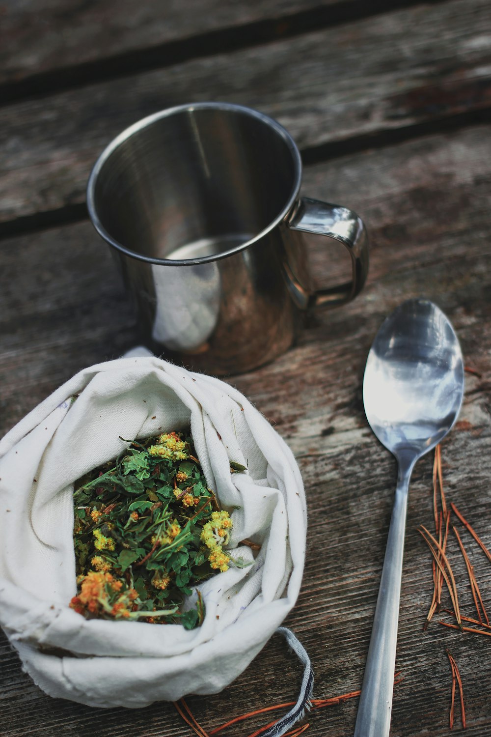 stainless steel spoon beside vegetable salad in stainless steel cup