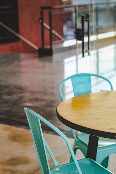 brown wooden table and green chair
