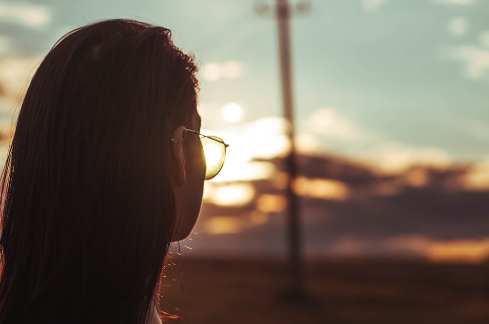 woman wearing black framed eyeglasses during sunset