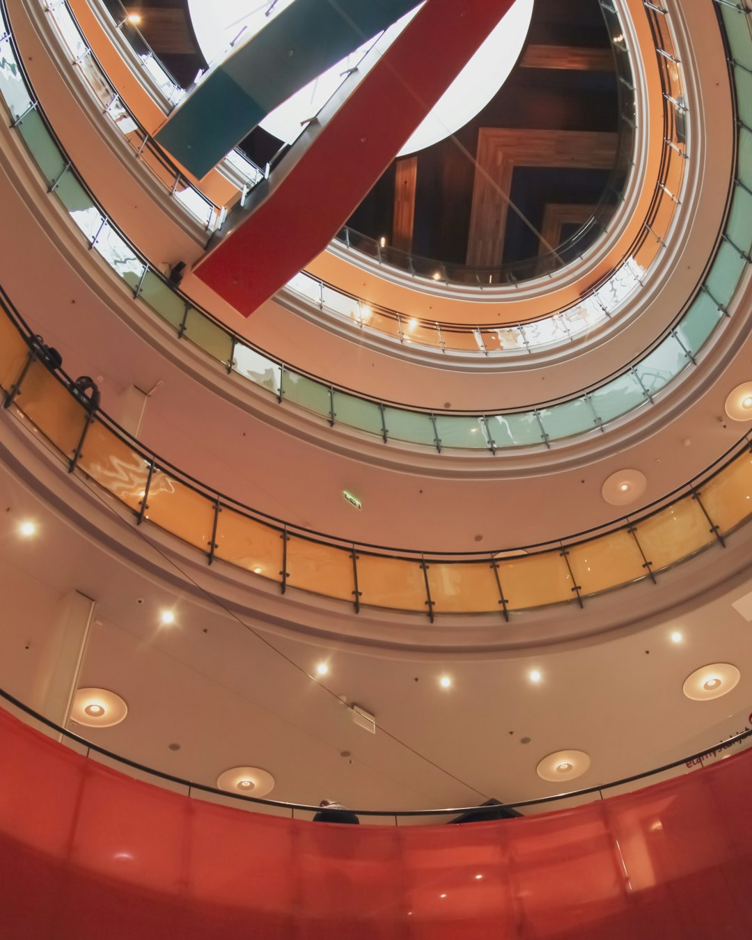 brown spiral staircase with red ceiling