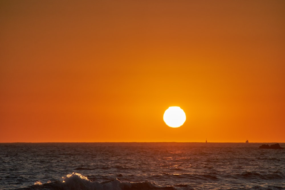 body of water during sunset