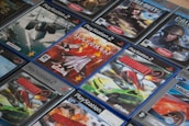 A collection of PlayStation 3 game cases arranged neatly on a shelf.
