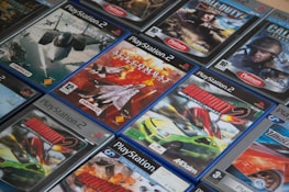A collection of PlayStation 3 game cases arranged neatly on a shelf.